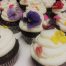 6 cupcakes with icing and flowers on top