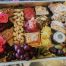 A collection of cold meats, dessert, pickles, fruit and nuts for grazing.